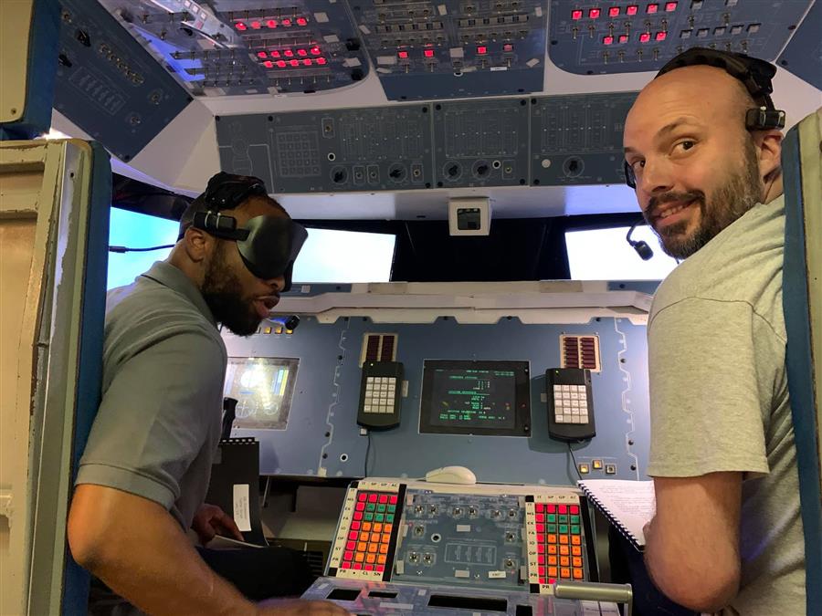 Commander and pilot look back while preparing for takeoff.